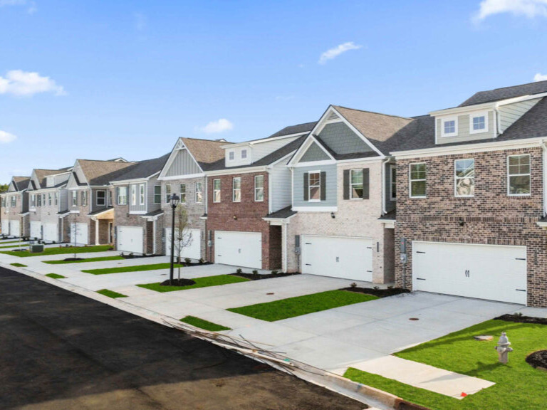 a row of townhomes with different siding 