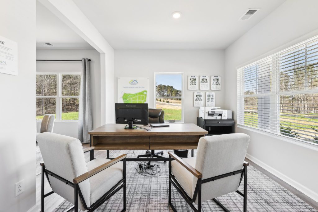 an office with a map of a community in the background and a window that shows the outside 