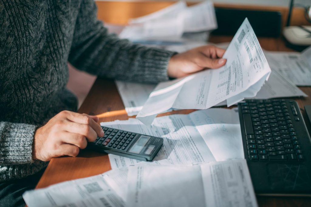Person reviewing bills while facing rising rent costs in Metro Atlanta ©Grusho Anna