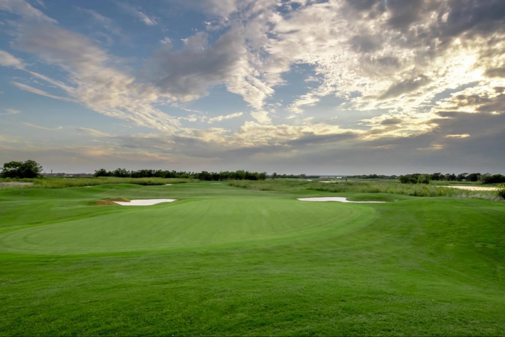 the championship golf course at Heath Golf and Yacht Club with sun shining through the clouds