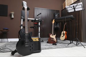 Music room with guitars, drum set, and acoustic panels
©New Africa