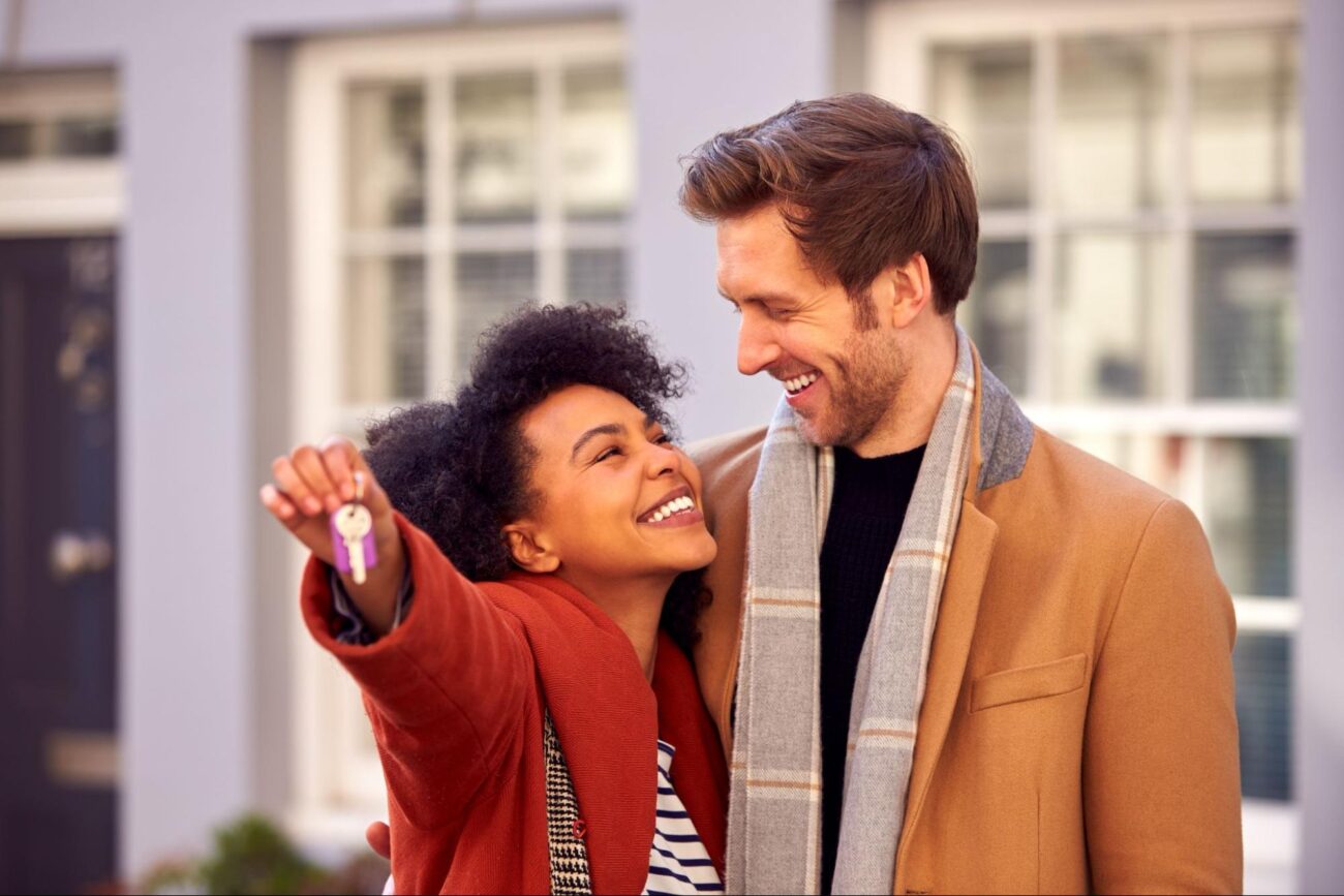 Couple celebrating with keys to their new home in Metro Atlanta during fall ©