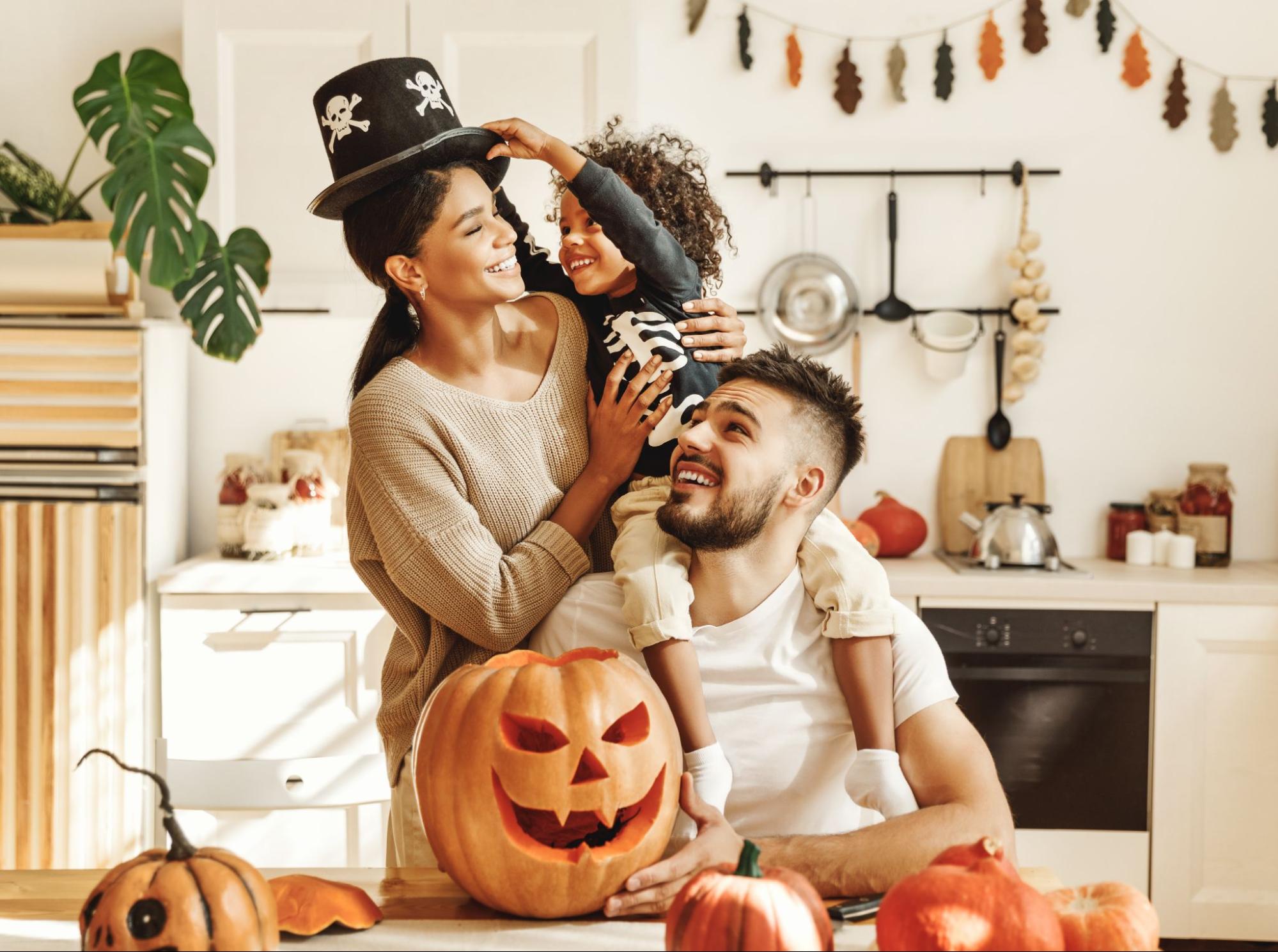 A family of 3 at home during Halloween having fun with seasonal decorations ©Evgeny Atamanenko