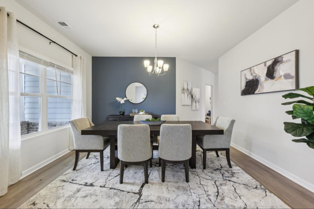 Decorated formal dining room with a table and chairs in Stephen's Landing, a new construction community in Loganville.