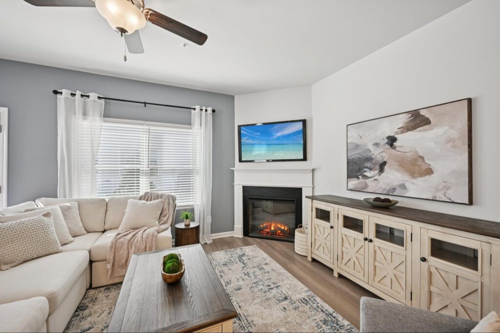 Bright living room with fireplace inside a Chastain Heights townhome by Direct Residential Communities in Woodstock, GA.