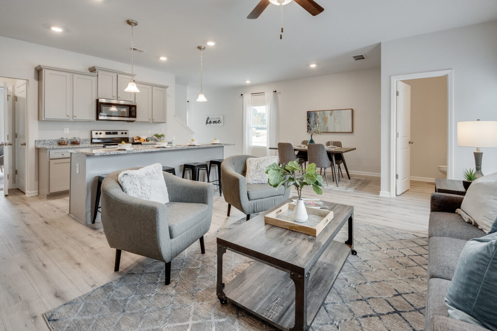 nterior of a decorated Creekside Village townhome in Lithonia, GA showing living room and kitchen with modern finishes