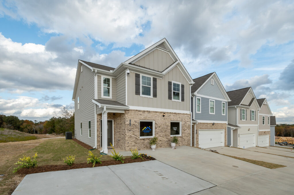 View from the street of new townhomes in Lithonia, GA at Creekside Village