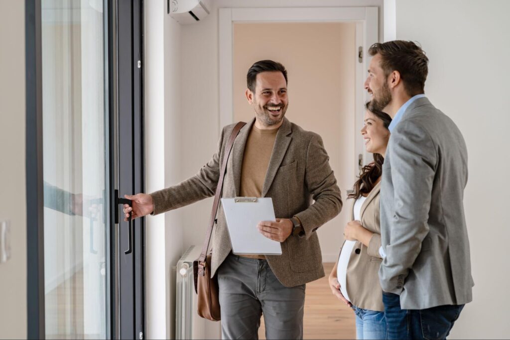 Homebuyers touring a house with a real estate professional during a showing ©Lordn