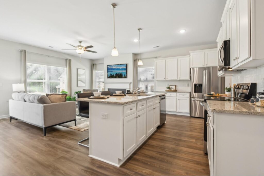 Open kitchen with large island and living area in a new construction home