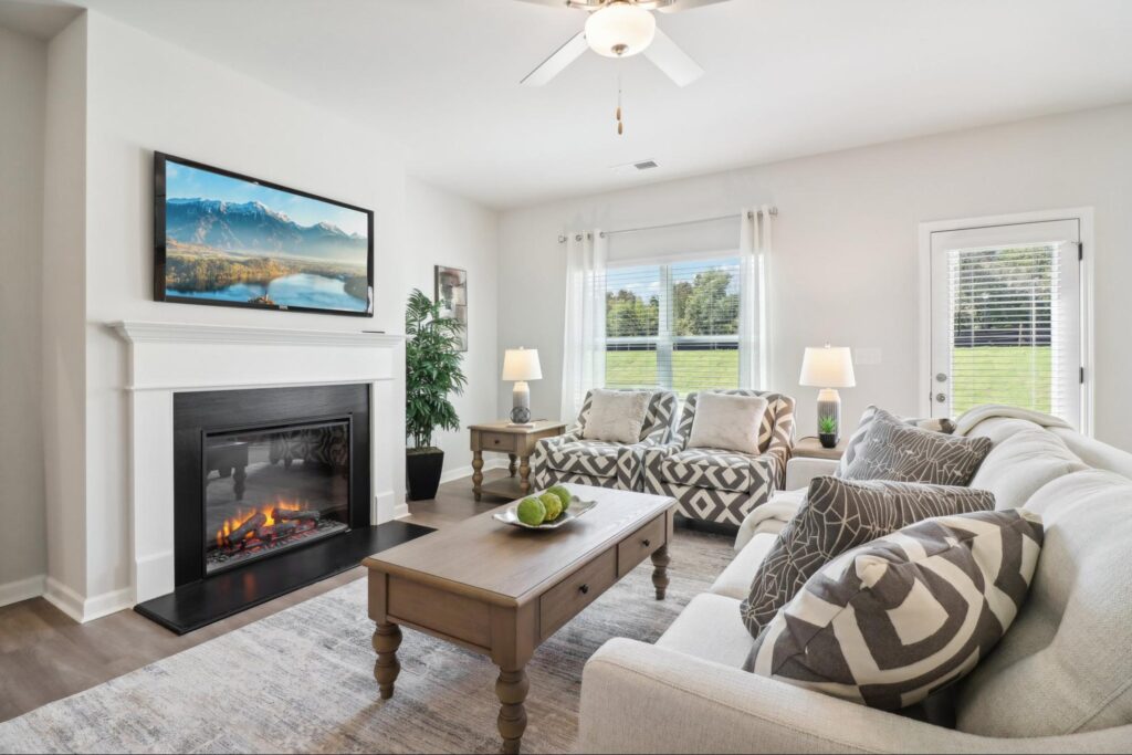 Open concept living room with fireplace in a new home in Covington, GA.
