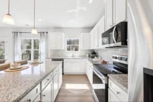 Gourmet kitchen with a granite island in a new home in Winder, GA.