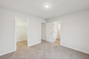 Spacious secondary bedroom with a walk-in closet in the Brentwood floor plan. 