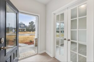 Foyer with glass-paneled French doors in a new Loganville home. 