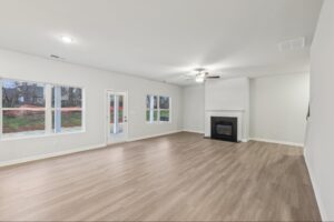 Open concept great room with a gas fireplace and luxury vinyl plank flooring. 