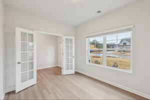 Flexible formal living area with natural light and white trim in the Brentwood plan. 