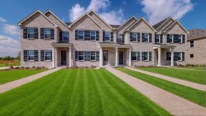 Luxury brick townhomes and row houses with manicured lawns at Solterra Texas. 