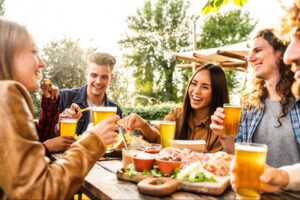 Friends enjoying food and drinks at a brewery in Woodstock, GA. ©DavideAngelini