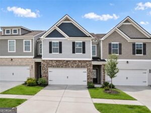 Exterior front view of new townhomes with stone accents at Creekside Village in Lithonia, Georgia.